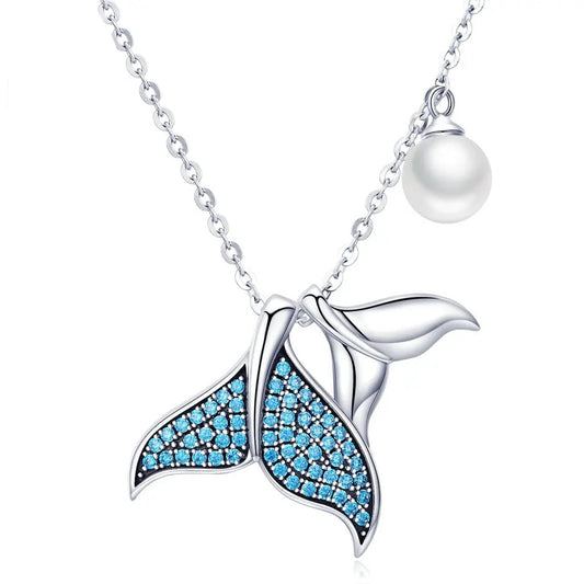 Silver whale tail necklace with blue gemstones.