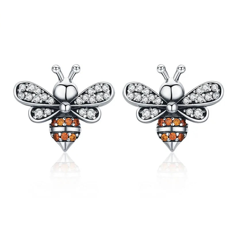 Silver bee earrings with cubic zirconia gemstones.