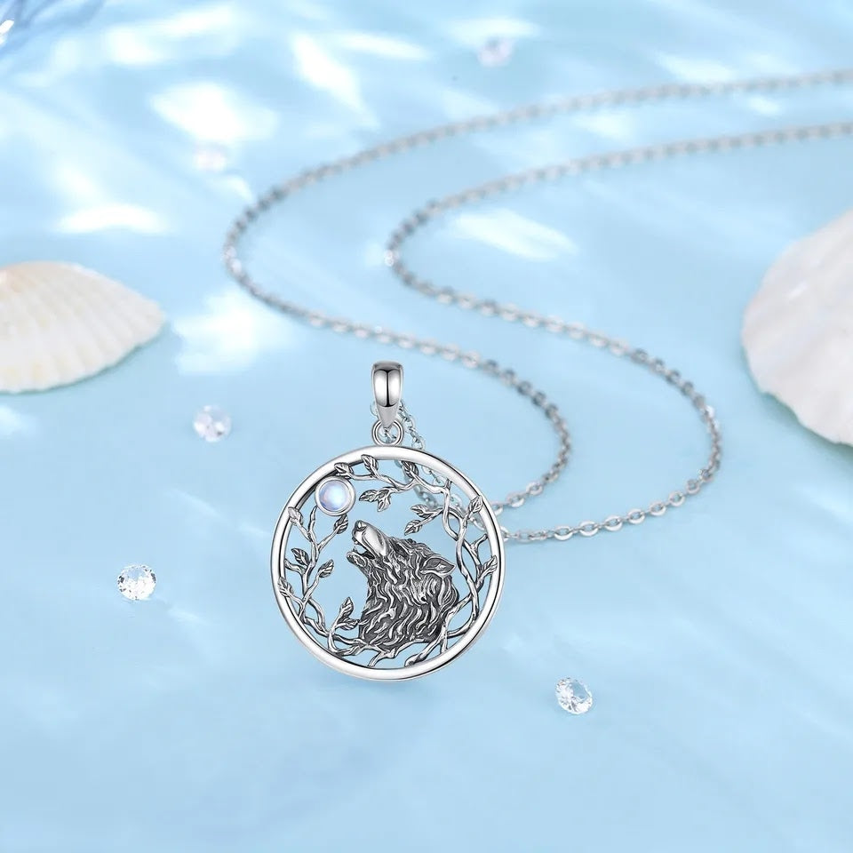 Circular wolf and moon necklace in sterling silver, with moonstone.